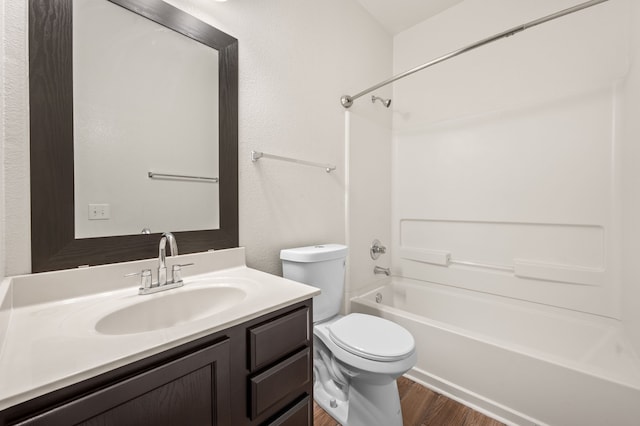 full bathroom featuring wood-type flooring, shower / bath combination, toilet, and vanity