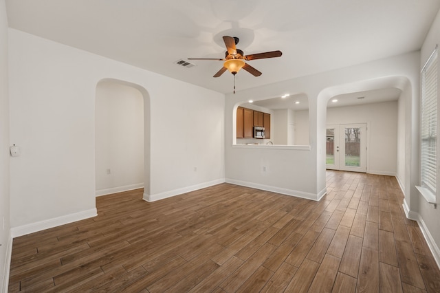 unfurnished living room featuring ceiling fan