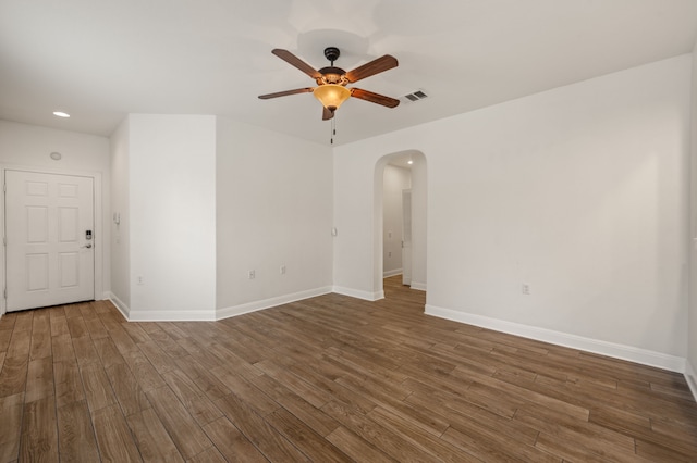 spare room featuring ceiling fan and dark hardwood / wood-style floors