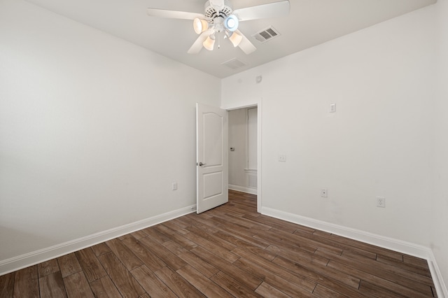 unfurnished room featuring dark wood-type flooring and ceiling fan