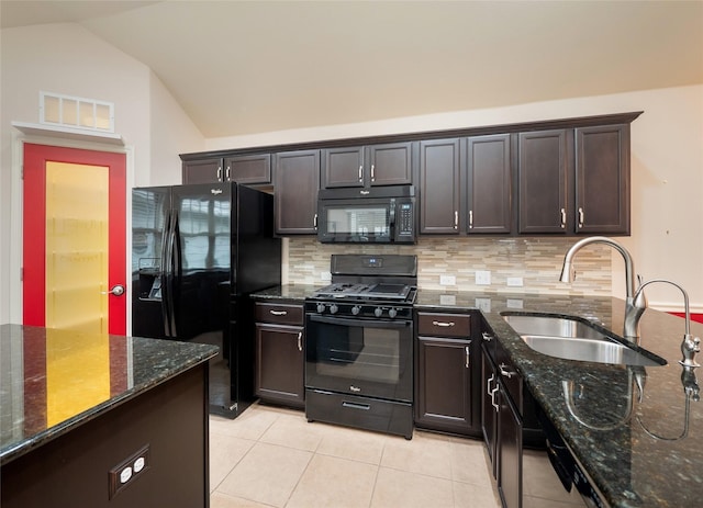 kitchen featuring black appliances, dark stone countertops, sink, backsplash, and vaulted ceiling