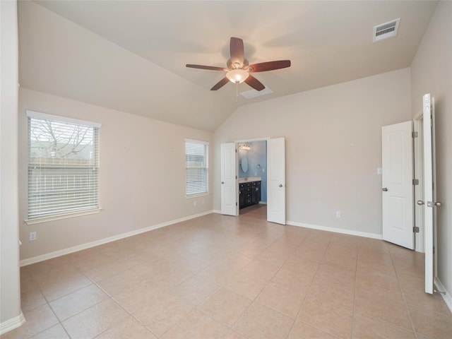 unfurnished room with ceiling fan, light tile patterned floors, and vaulted ceiling