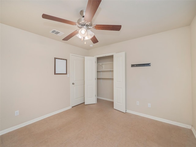 unfurnished bedroom featuring ceiling fan, light tile patterned flooring, and a closet