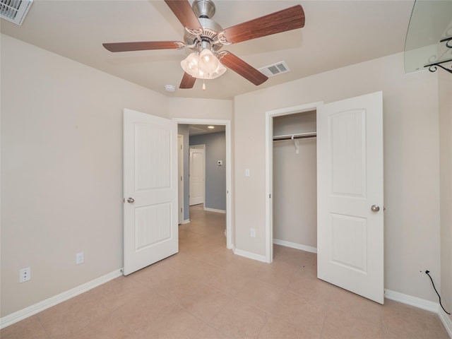 unfurnished bedroom with ceiling fan, light tile patterned floors, and a closet