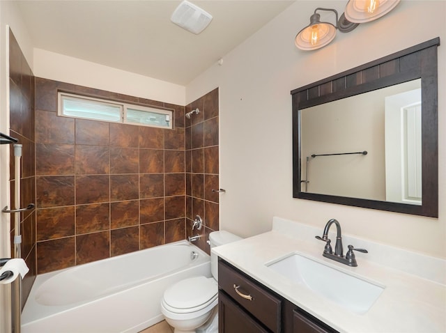 full bathroom featuring toilet, tiled shower / bath combo, and vanity