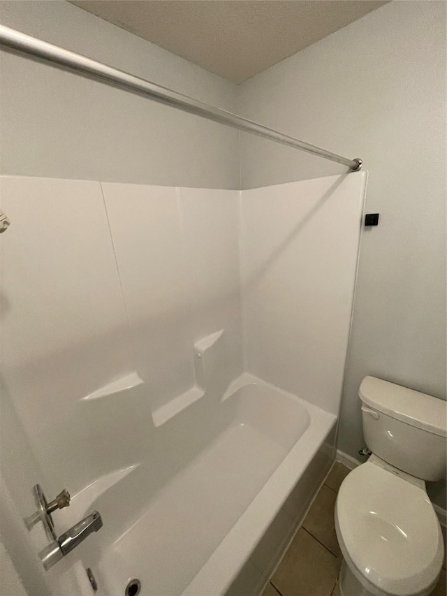 bathroom with toilet and tile patterned flooring