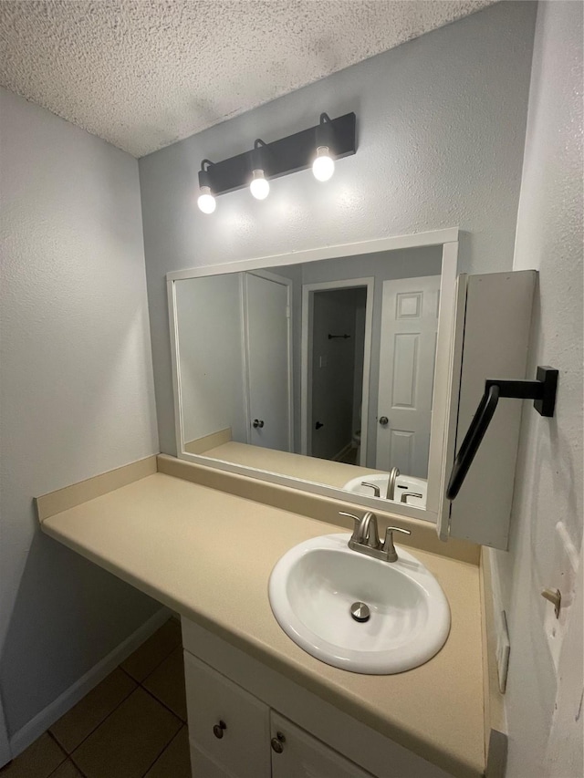 bathroom featuring vanity, tile patterned flooring, and a textured ceiling