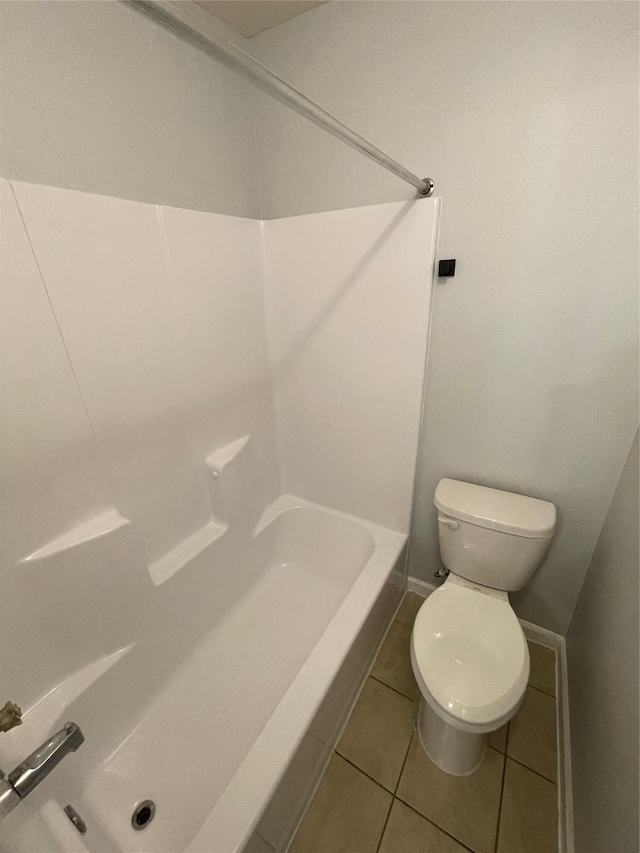 bathroom with toilet and tile patterned flooring