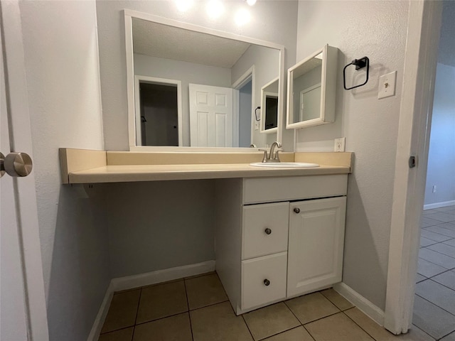 bathroom with tile patterned flooring and vanity