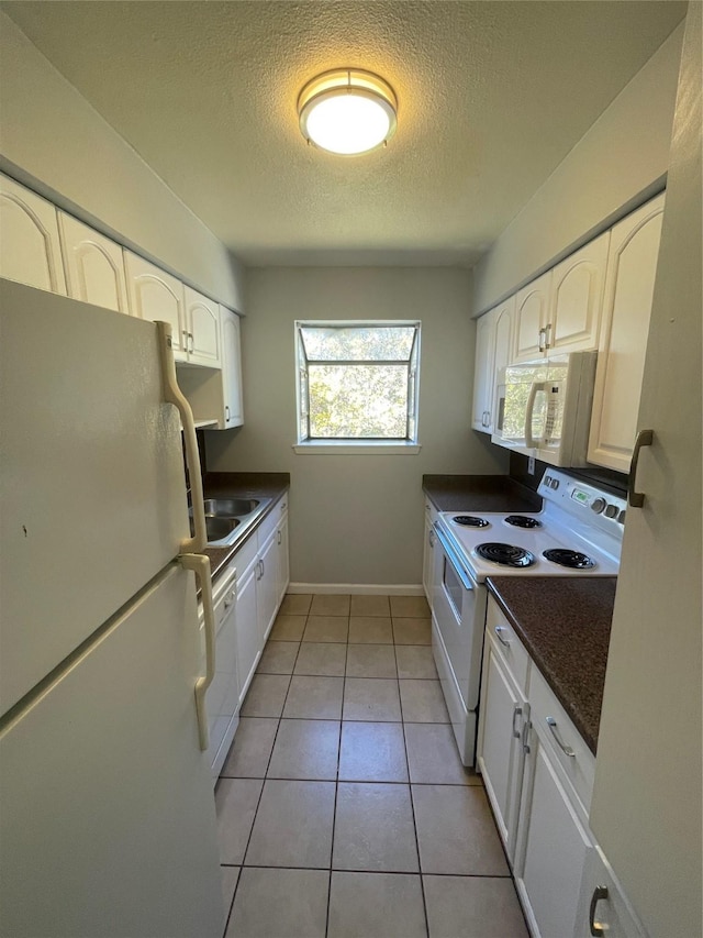 kitchen featuring white cabinetry, white appliances, and a textured ceiling