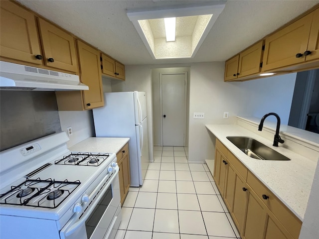 kitchen with sink, white appliances, and light tile patterned floors