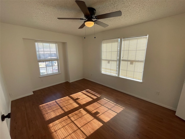 unfurnished room featuring ceiling fan, dark hardwood / wood-style flooring, and a textured ceiling