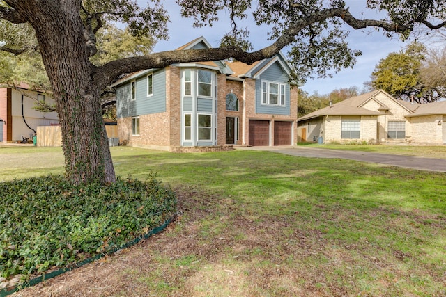 view of front of home with a front lawn and a garage