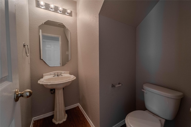 bathroom featuring toilet and hardwood / wood-style floors