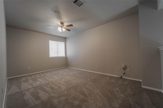 carpeted spare room with ceiling fan