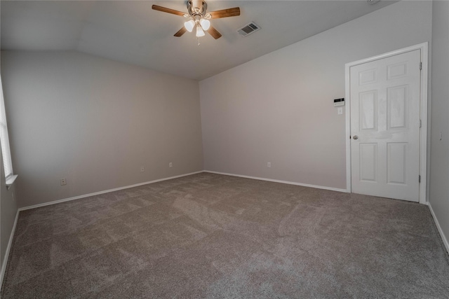 carpeted empty room featuring ceiling fan and vaulted ceiling