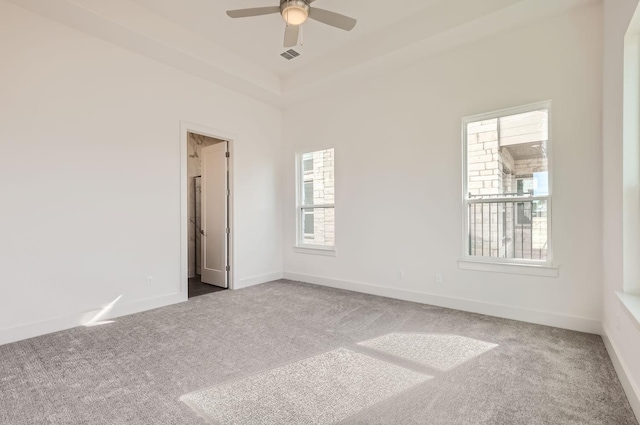 carpeted spare room featuring ceiling fan