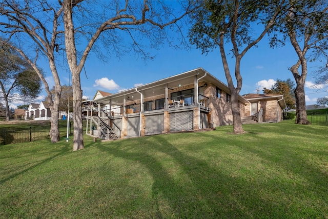 exterior space with a wooden deck and a lawn