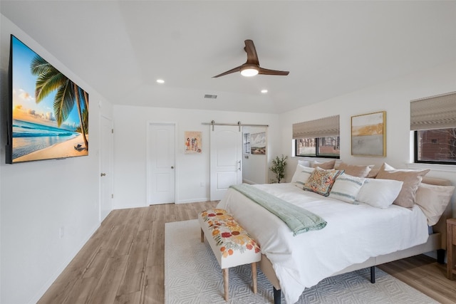150 Turtle Ln, Seguin, TX 78155 - bedroom featuring light wood-style flooring, a barn door, recessed lighting, a ceiling fan, and baseboards