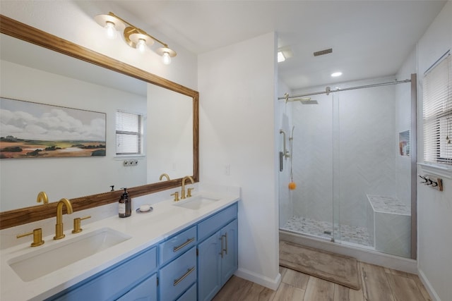 150 Turtle Ln, Seguin, TX 78155 - bathroom featuring wood finished floors, double vanity, a shower stall, and baseboards