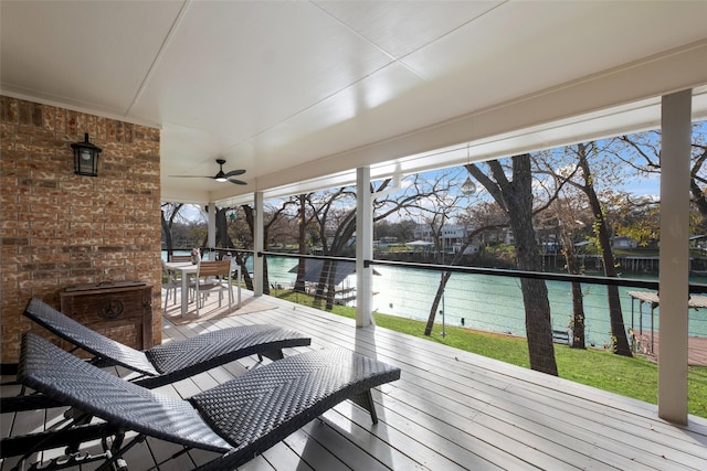 wooden deck featuring a water view and ceiling fan