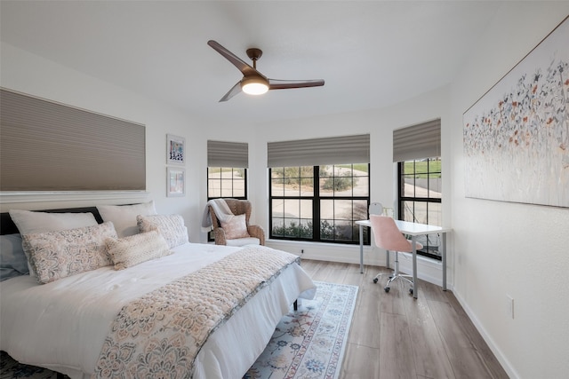 bedroom with ceiling fan and light hardwood / wood-style floors