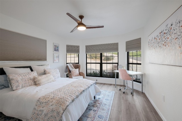 150 Turtle Ln, Seguin, TX 78155 - bedroom with wood finished floors, baseboards, a ceiling fan, and a desk