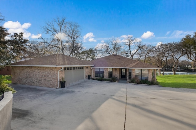 150 Turtle Ln, Seguin, TX 78155 - ranch-style home featuring an attached garage, driveway, brick siding, and a front lawn