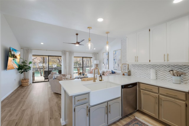 kitchen with sink, hanging light fixtures, lofted ceiling, and kitchen peninsula