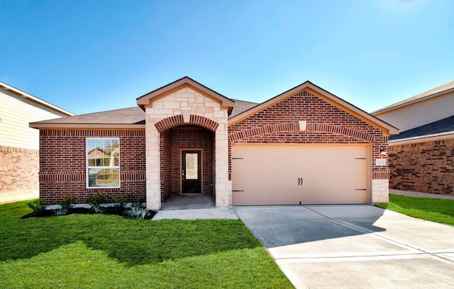 view of front of property with a front yard and a garage