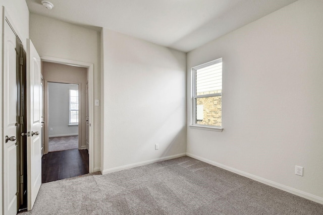 carpeted empty room with plenty of natural light