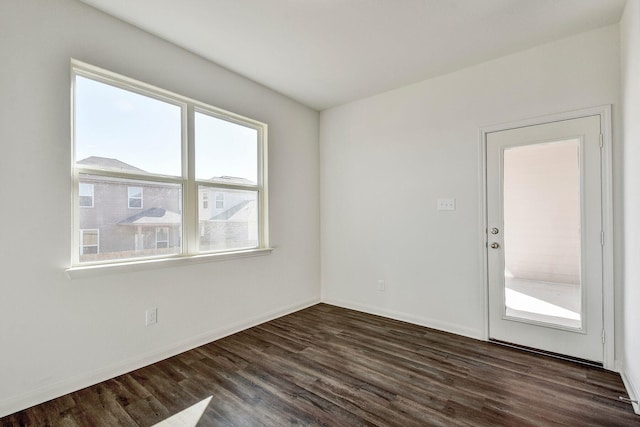 unfurnished room with a healthy amount of sunlight and dark hardwood / wood-style floors