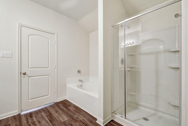 bathroom with lofted ceiling, independent shower and bath, and hardwood / wood-style flooring