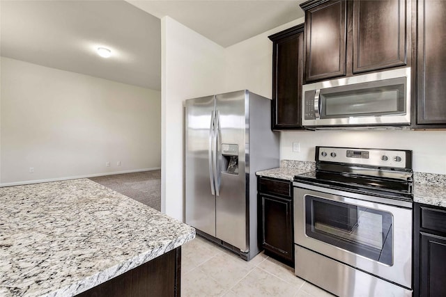 kitchen with light tile patterned floors, appliances with stainless steel finishes, and dark brown cabinets