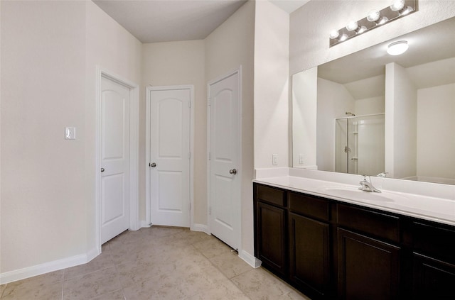 bathroom featuring tile patterned floors, walk in shower, and vanity