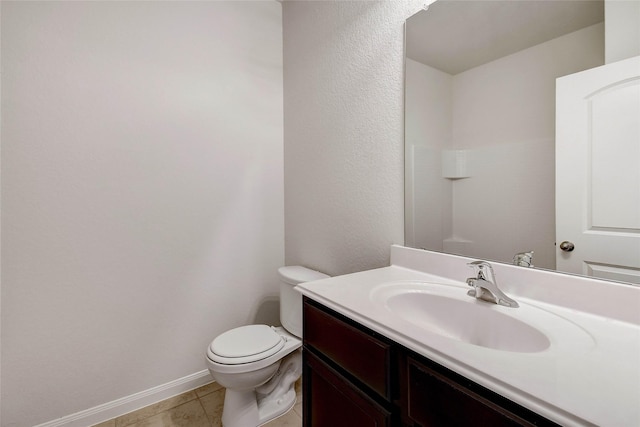 bathroom featuring toilet, vanity, and tile patterned floors