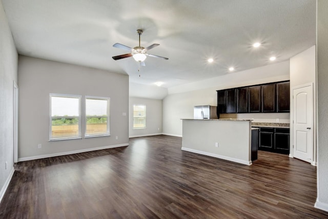 kitchen featuring stainless steel fridge with ice dispenser, ceiling fan, dark hardwood / wood-style floors, and a center island