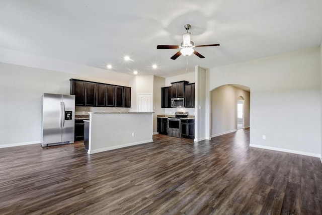 unfurnished living room featuring dark wood-type flooring and ceiling fan