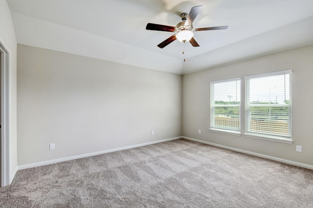 unfurnished room featuring light carpet, vaulted ceiling, and ceiling fan