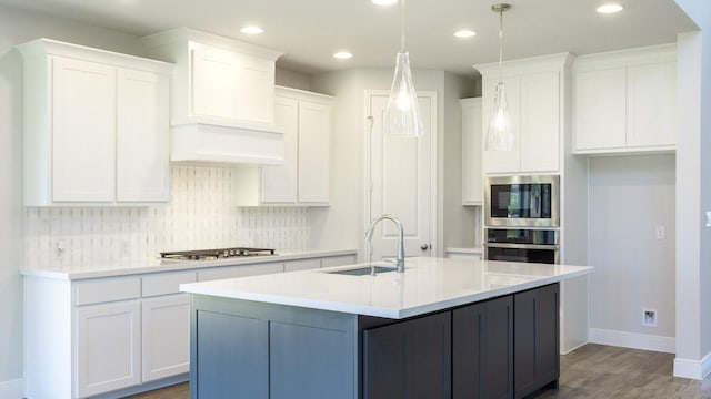117 White Creek Ln, Georgetown, TX 78628 - kitchen with appliances with stainless steel finishes, white cabinets, wood finished floors, decorative backsplash, and recessed lighting