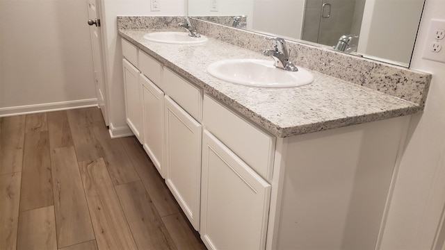 bathroom featuring vanity and wood-type flooring