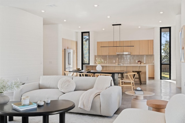 living room with floor to ceiling windows and sink