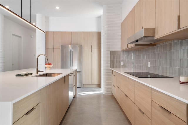 kitchen with light brown cabinetry, appliances with stainless steel finishes, and sink