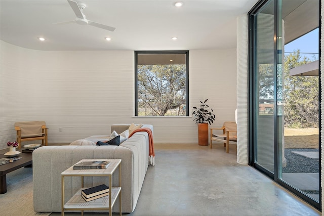 living room featuring ceiling fan and a wealth of natural light