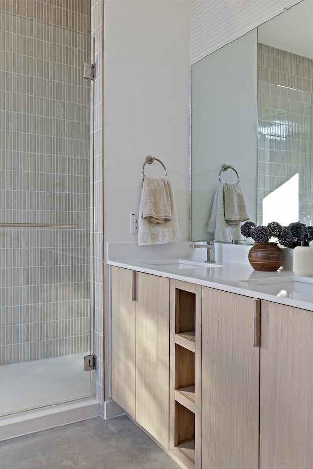 bathroom with an enclosed shower, vanity, and concrete floors