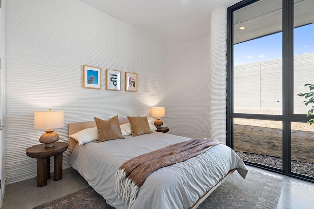 bedroom featuring concrete flooring