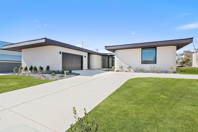 view of front of house with a front yard and a garage