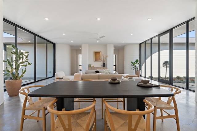 dining space featuring ceiling fan and floor to ceiling windows