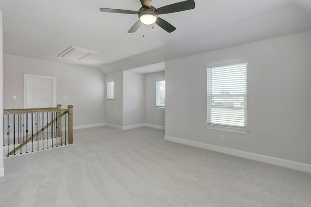 empty room with light carpet and vaulted ceiling