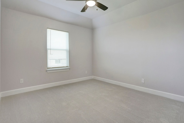 unfurnished room with ceiling fan, light carpet, and vaulted ceiling